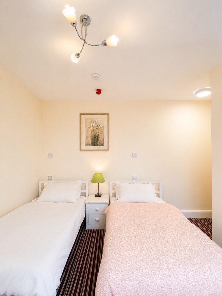 Twin room with two single beds and bedside table